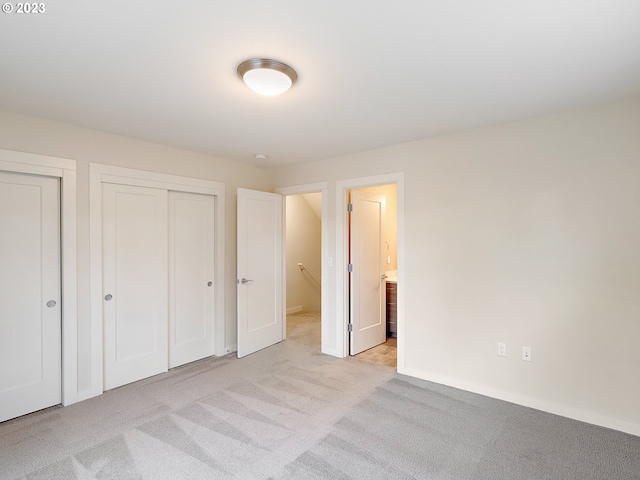 unfurnished bedroom featuring light carpet