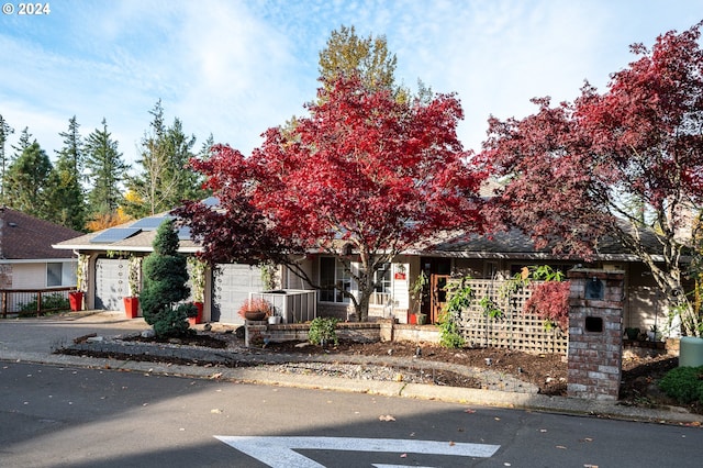 view of front of house with solar panels and a garage