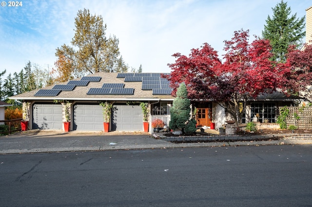 view of front of house with solar panels and a garage