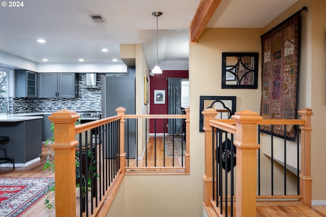 hallway featuring sink and light hardwood / wood-style floors