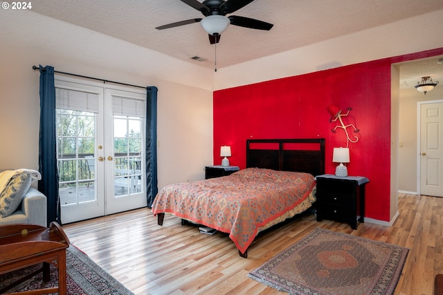 bedroom with access to exterior, french doors, a textured ceiling, ceiling fan, and wood-type flooring