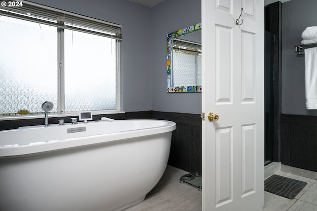 bathroom featuring a tub to relax in and tile patterned floors