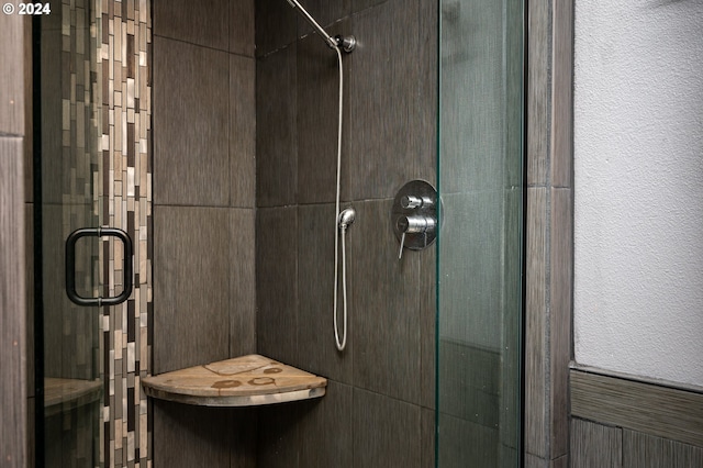 bathroom featuring a shower with door