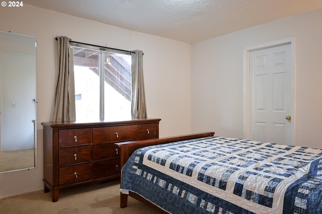 carpeted bedroom featuring a textured ceiling