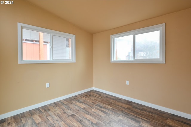 unfurnished room featuring wood-type flooring and lofted ceiling