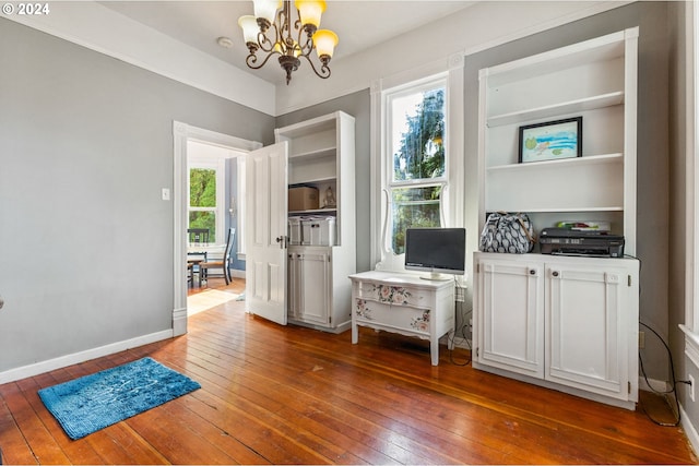 home office with a notable chandelier, a wealth of natural light, and dark hardwood / wood-style floors