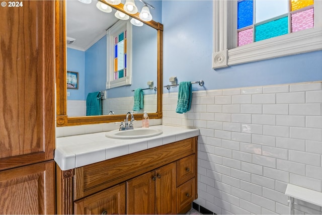 bathroom featuring vanity, tile walls, and ornamental molding