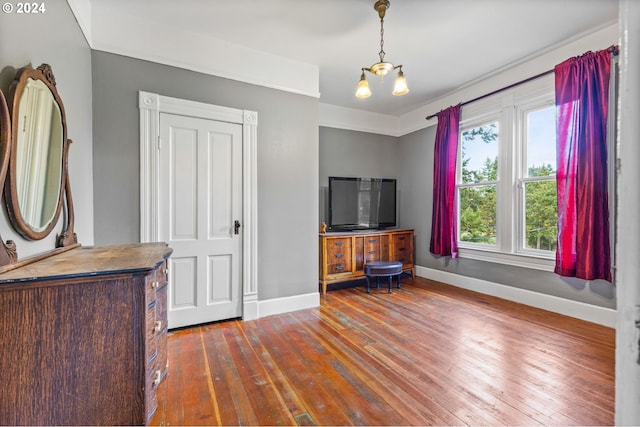 interior space with an inviting chandelier and dark hardwood / wood-style flooring