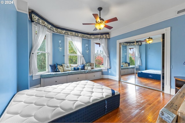 bedroom featuring a closet, hardwood / wood-style floors, and ceiling fan