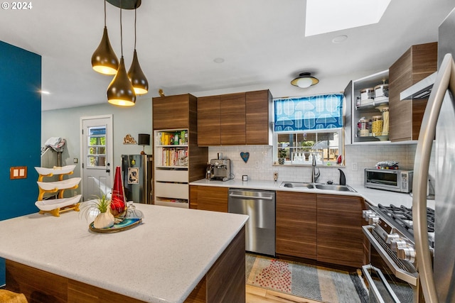 kitchen featuring light hardwood / wood-style flooring, backsplash, sink, stainless steel dishwasher, and stove