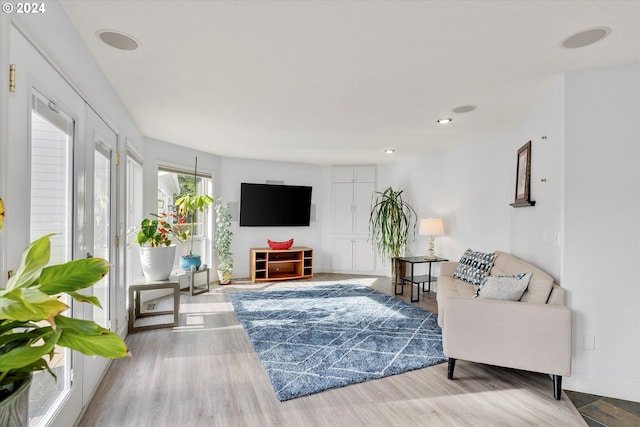 living room featuring recessed lighting, wood finished floors, and baseboards