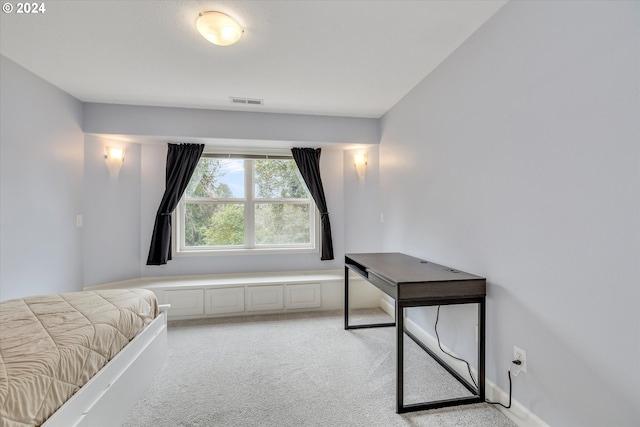 bedroom with light carpet, visible vents, and baseboards