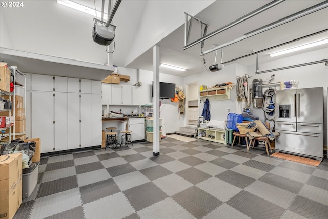 garage featuring high end fridge and a garage door opener