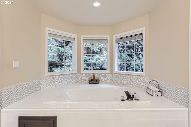 bathroom with a relaxing tiled tub