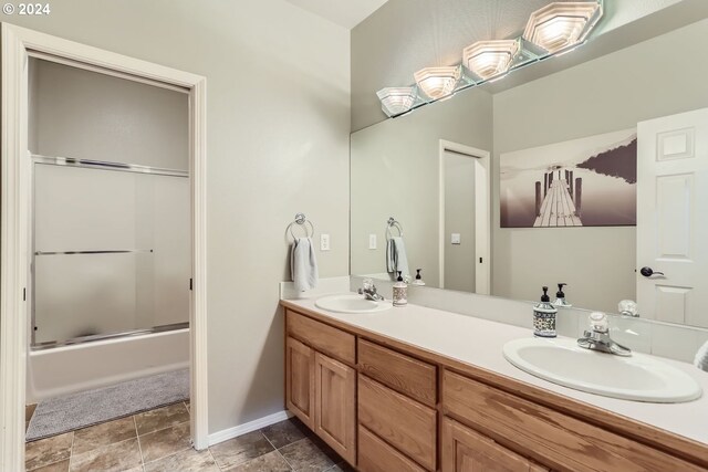 bathroom with enclosed tub / shower combo and vanity