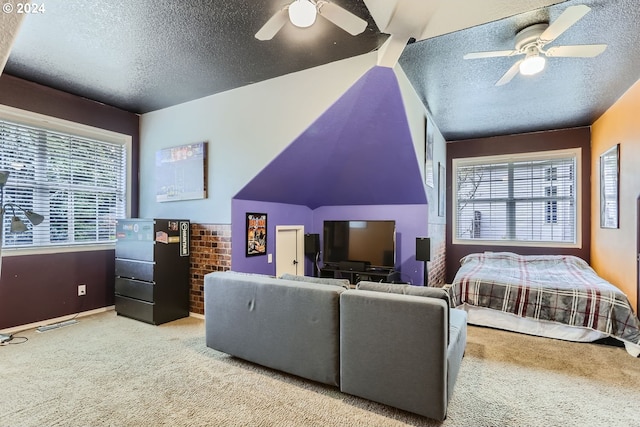 bedroom featuring light colored carpet, a textured ceiling, and ceiling fan