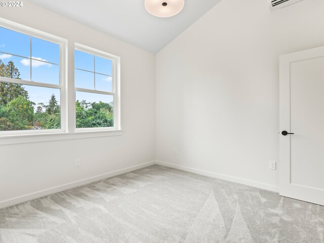 carpeted spare room featuring lofted ceiling