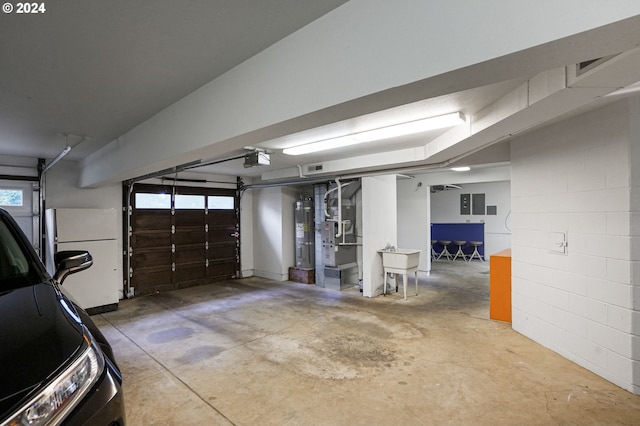 garage with a garage door opener and white refrigerator