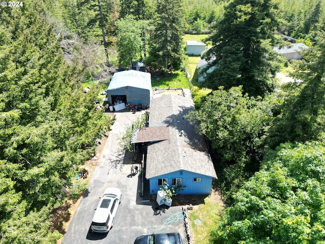 birds eye view of property with a view of trees