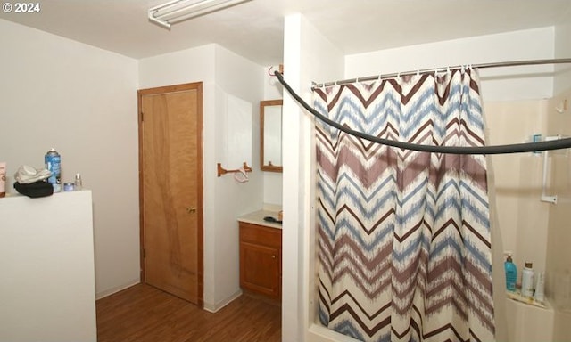 bathroom with vanity, a shower with curtain, and wood-type flooring