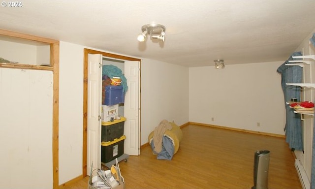 interior space with baseboards and wood finished floors