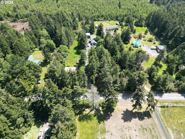 birds eye view of property with a forest view