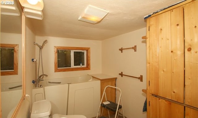 bathroom featuring toilet and shower / bathtub combination