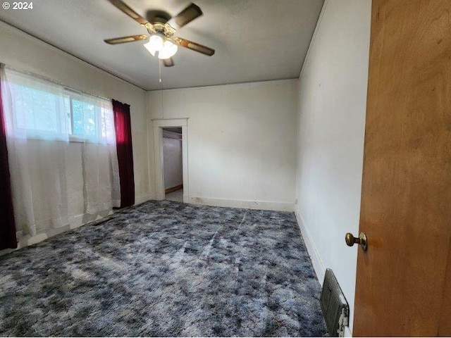 unfurnished bedroom featuring a ceiling fan, visible vents, baseboards, and carpet flooring