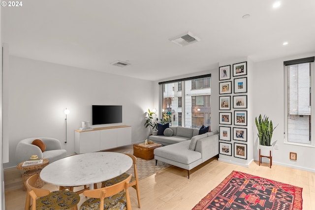 1150 NW Quimby St Unit 208, Portland, OR 97209 - living room featuring healthy amount of natural light, light wood-style floors, and recessed lighting