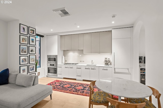 1150 NW Quimby St Unit 208, Portland, OR 97209 - kitchen with stainless steel appliances, recessed lighting, light countertops, arched walkways, and modern cabinets