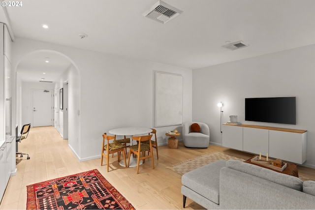 1150 NW Quimby St Unit 208, Portland, OR 97209 - living area featuring arched walkways, light wood-type flooring, and recessed lighting