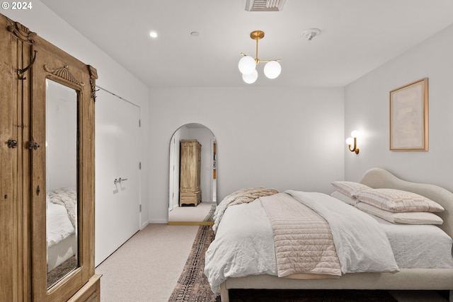 1150 NW Quimby St Unit 208, Portland, OR 97209 - bedroom featuring light carpet, arched walkways, and recessed lighting