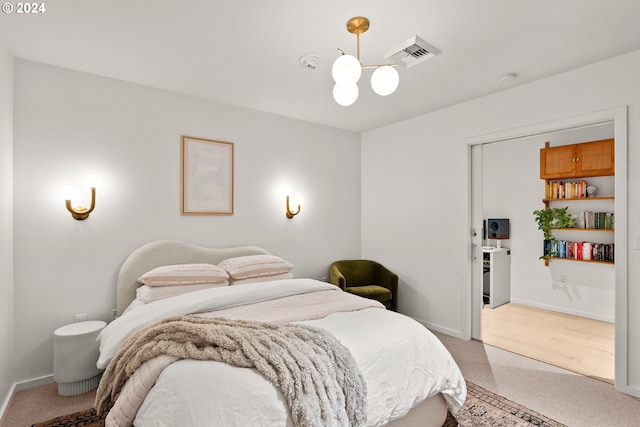 1150 NW Quimby St Unit 208, Portland, OR 97209 - bedroom featuring a chandelier and light carpet