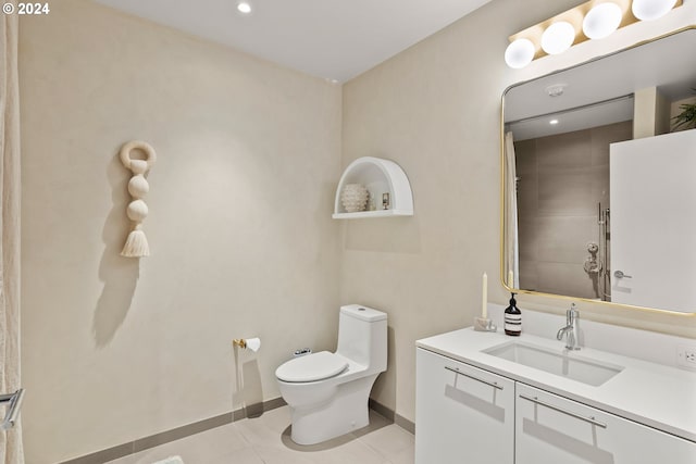 bathroom featuring tile patterned flooring, vanity, and toilet