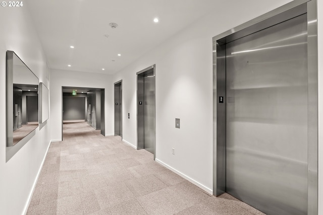 1150 NW Quimby St Unit 208, Portland, OR 97209 - corridor featuring elevator, light colored carpet, and recessed lighting