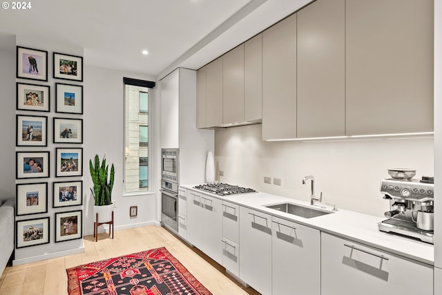 1150 NW Quimby St Unit 208, Portland, OR 97209 - kitchen featuring appliances with stainless steel finishes, light countertops, recessed lighting, light wood finished floors, and modern cabinets