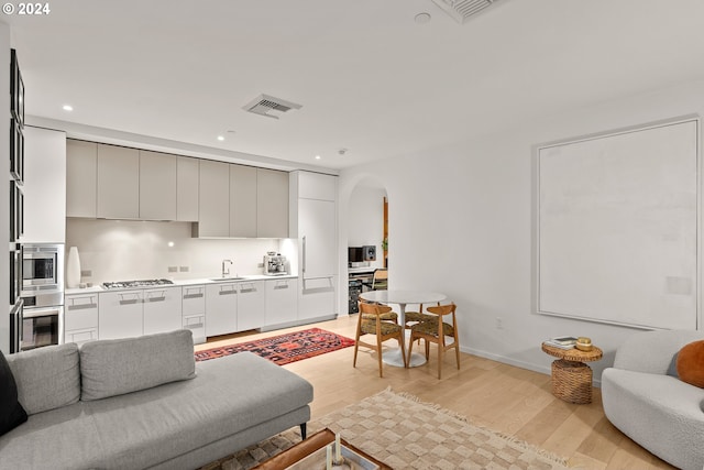 living room featuring light hardwood / wood-style floors and sink