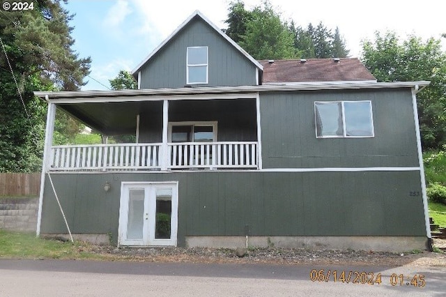 back of house featuring a balcony and french doors