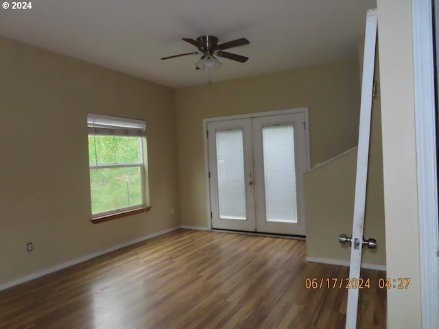 unfurnished room with hardwood / wood-style flooring, ceiling fan, and french doors