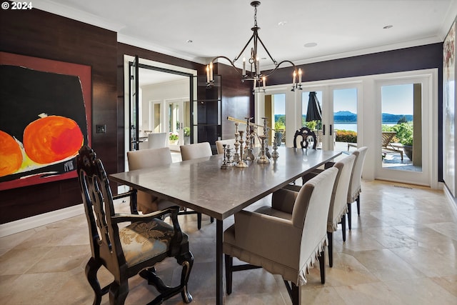 dining area featuring ornamental molding, wooden walls, a chandelier, and french doors