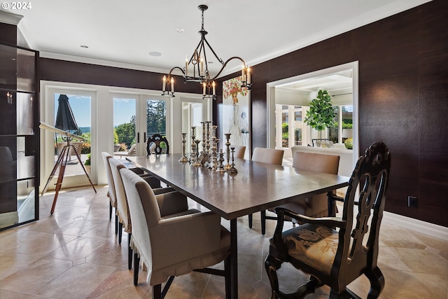 dining area with a notable chandelier, crown molding, french doors, and plenty of natural light