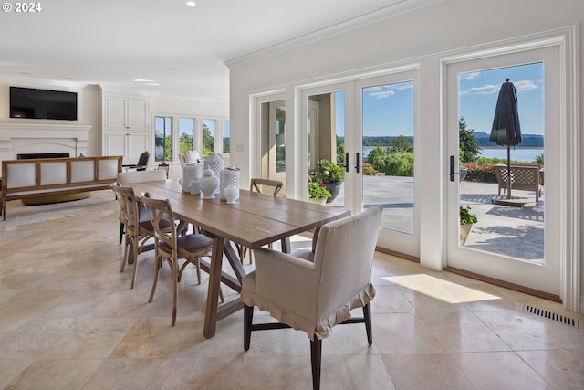 dining space featuring a water view and french doors