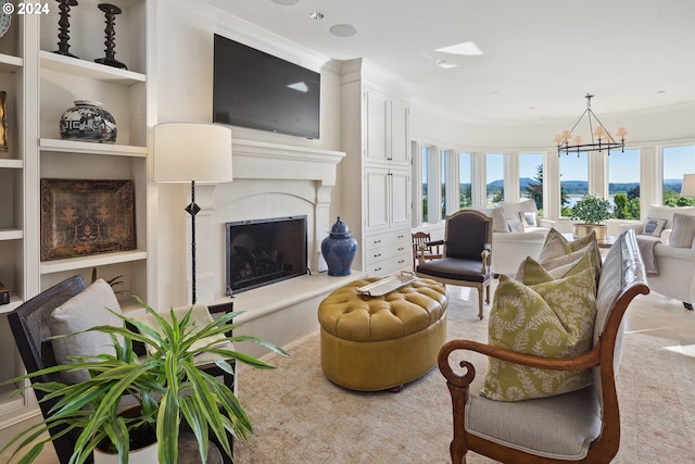 living room with an inviting chandelier, built in features, crown molding, and a healthy amount of sunlight