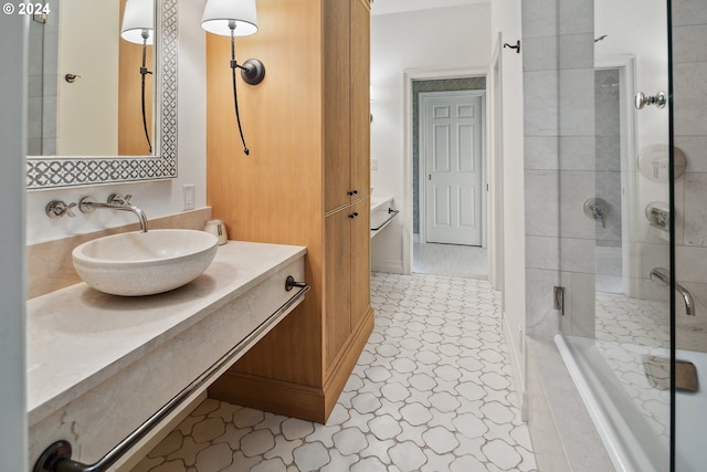 bathroom with a shower with door and vanity