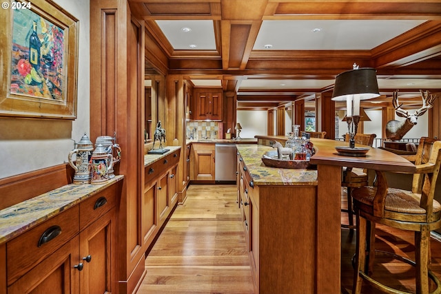 kitchen with coffered ceiling, light hardwood / wood-style flooring, a kitchen breakfast bar, light stone countertops, and stainless steel dishwasher