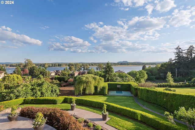 surrounding community featuring a water view and a yard