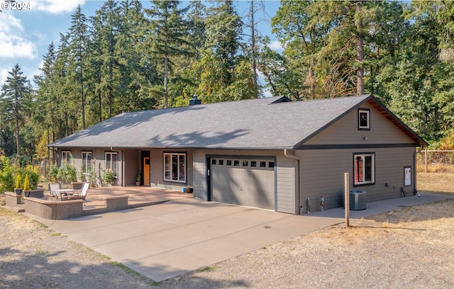 ranch-style home featuring a patio area and a garage