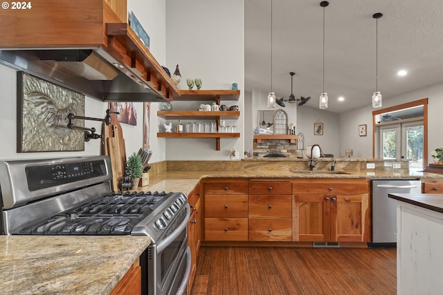 kitchen featuring sink, dark hardwood / wood-style flooring, decorative light fixtures, exhaust hood, and appliances with stainless steel finishes