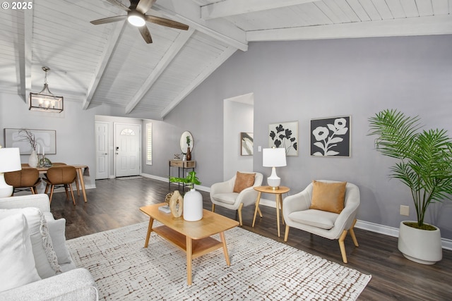 living room with ceiling fan with notable chandelier, dark wood-type flooring, and lofted ceiling with beams