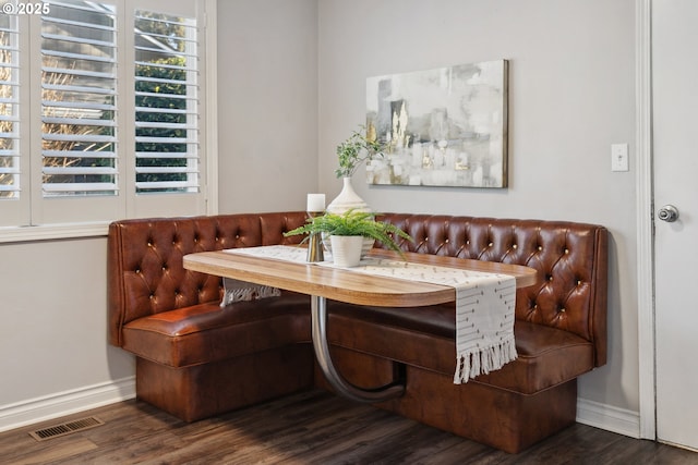 dining space featuring breakfast area and dark hardwood / wood-style floors